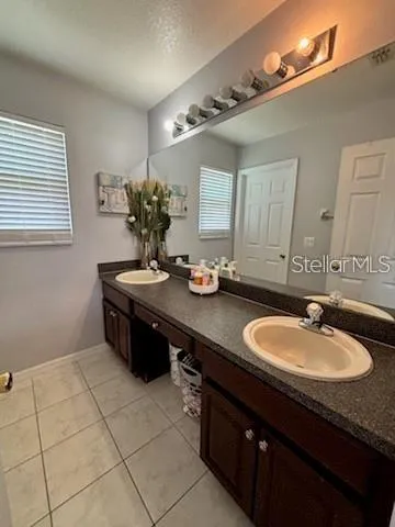 a bathroom with a sink a vanity and a mirror