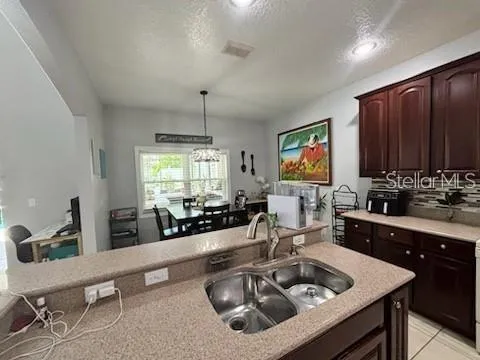 a kitchen with sink stove and cabinets