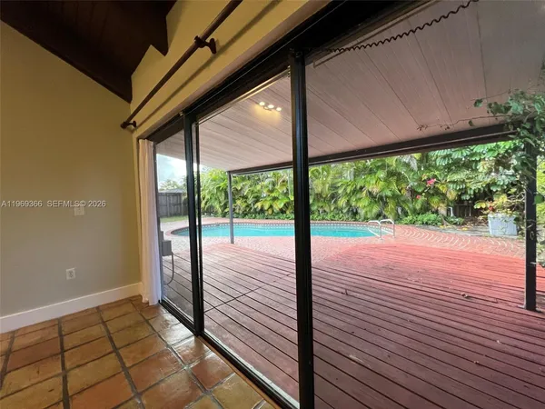 a view of a room with wooden floor and outdoor space
