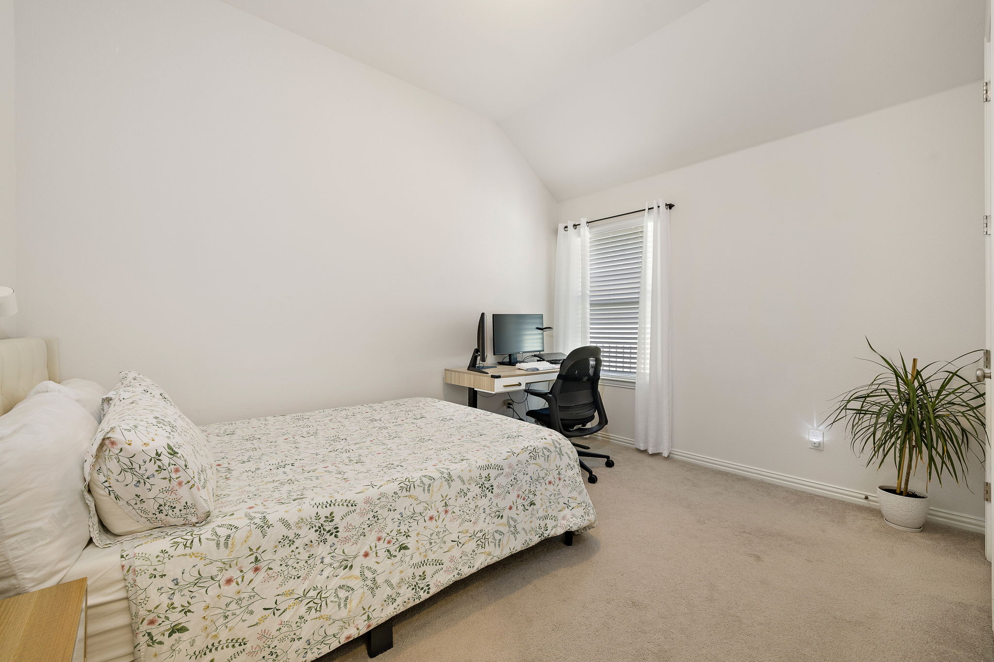4201 Vespa Cove Leander, TX 78641 - Photo 13 of 29 a bedroom with a bed and a potted plant