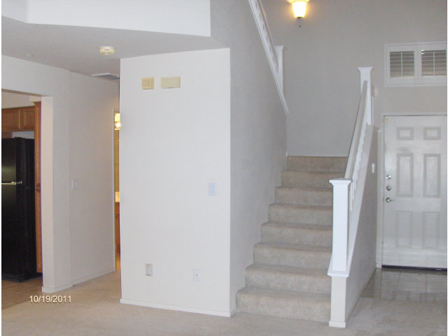 20 Torregata Loop San Jose, CA 95134 - Photo 2 of 12 a view of staircase with white walls and white door