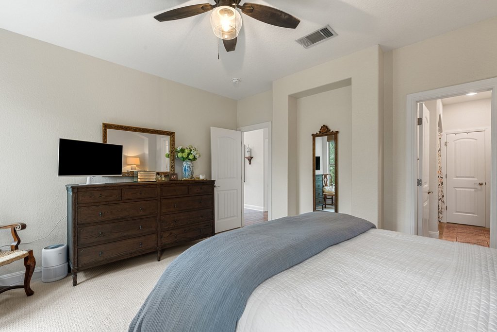 6708 Menchaca Road, Unit 2 Austin, TX 78745 - Photo 21 of 30 Carpeted room featuring a ceiling fan with integrated lighting, recessed wall niche, and an archway leading to an additional space with tile flooring