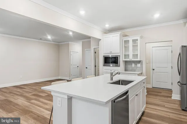 a kitchen with a sink and refrigerator