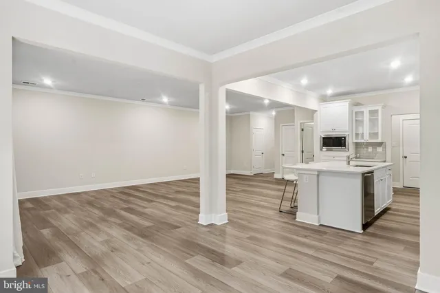 a view of kitchen with wooden floor and electronic appliances