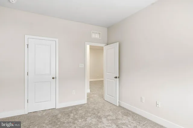 an empty room with closet area