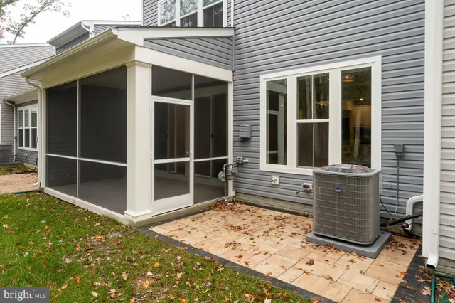 a view of a house with a large window and wooden fence