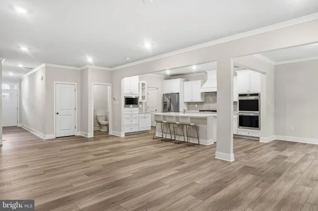 a view of kitchen with furniture and wooden floor