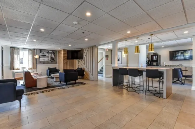 a room with lots of furniture and a view of dining room