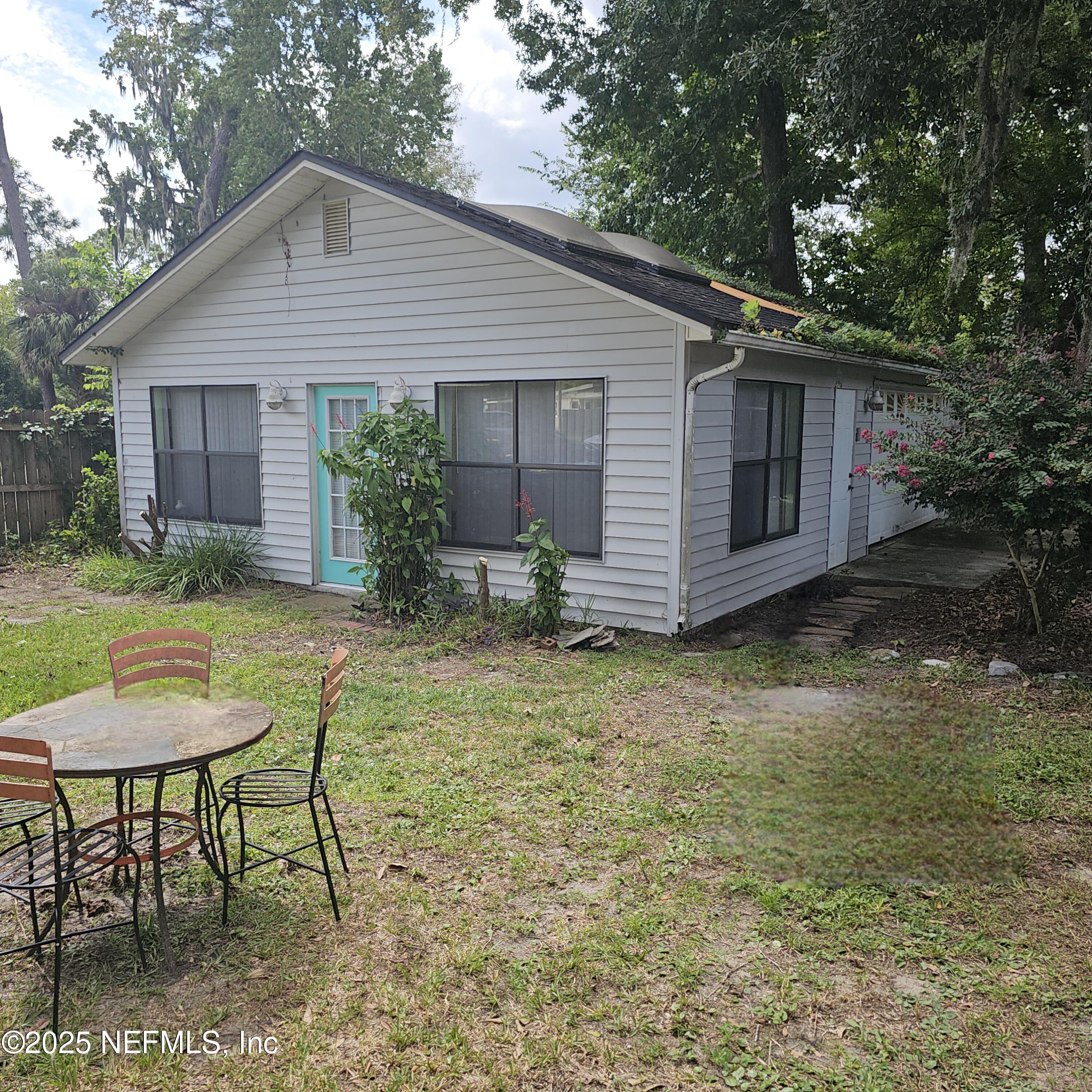 10596 Rutgers Road Jacksonville, FL 32218 - Photo 12 of 15 a backyard of a house with table and chairs