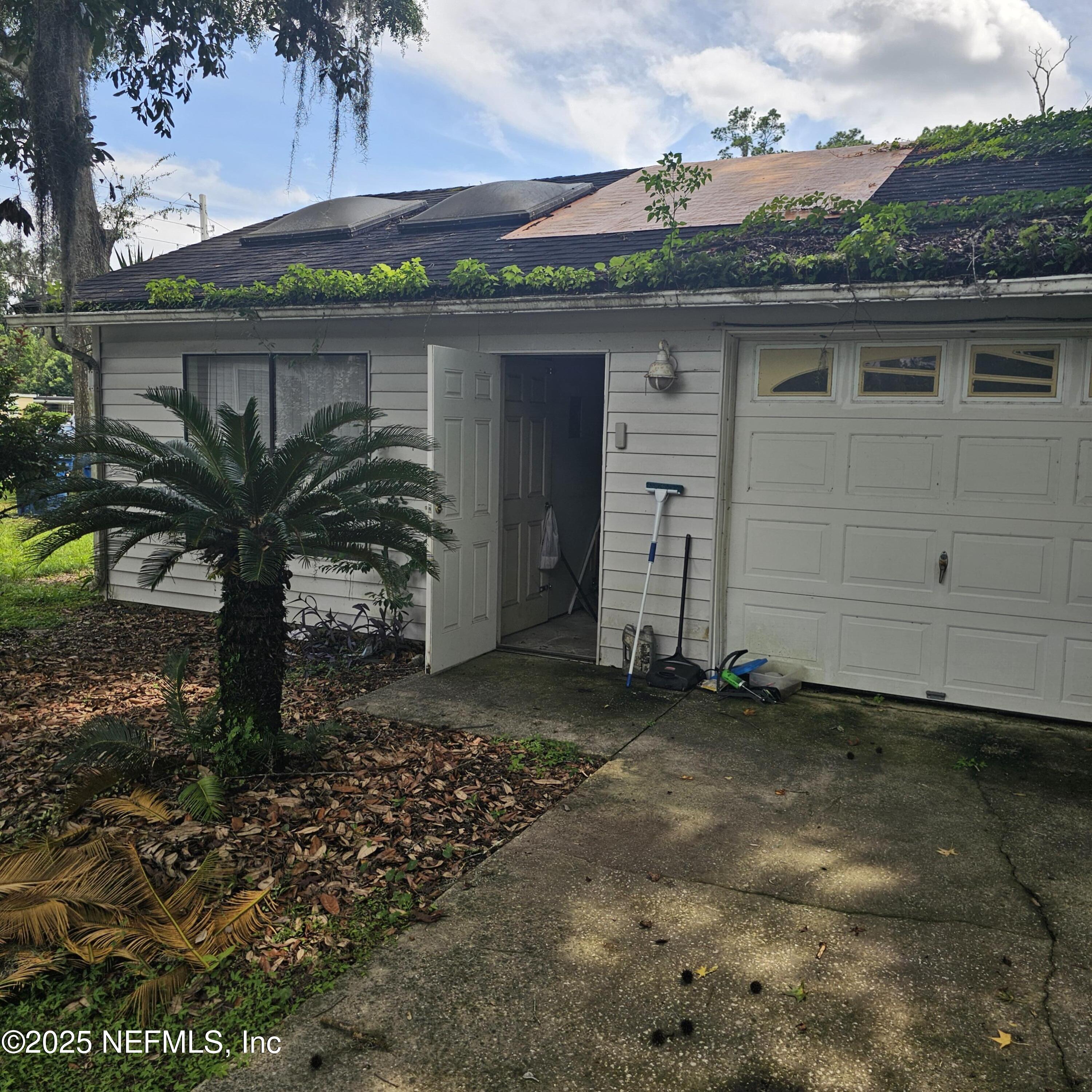 10596 Rutgers Road Jacksonville, FL 32218 - Photo 13 of 15 a view of a house with a yard and garage