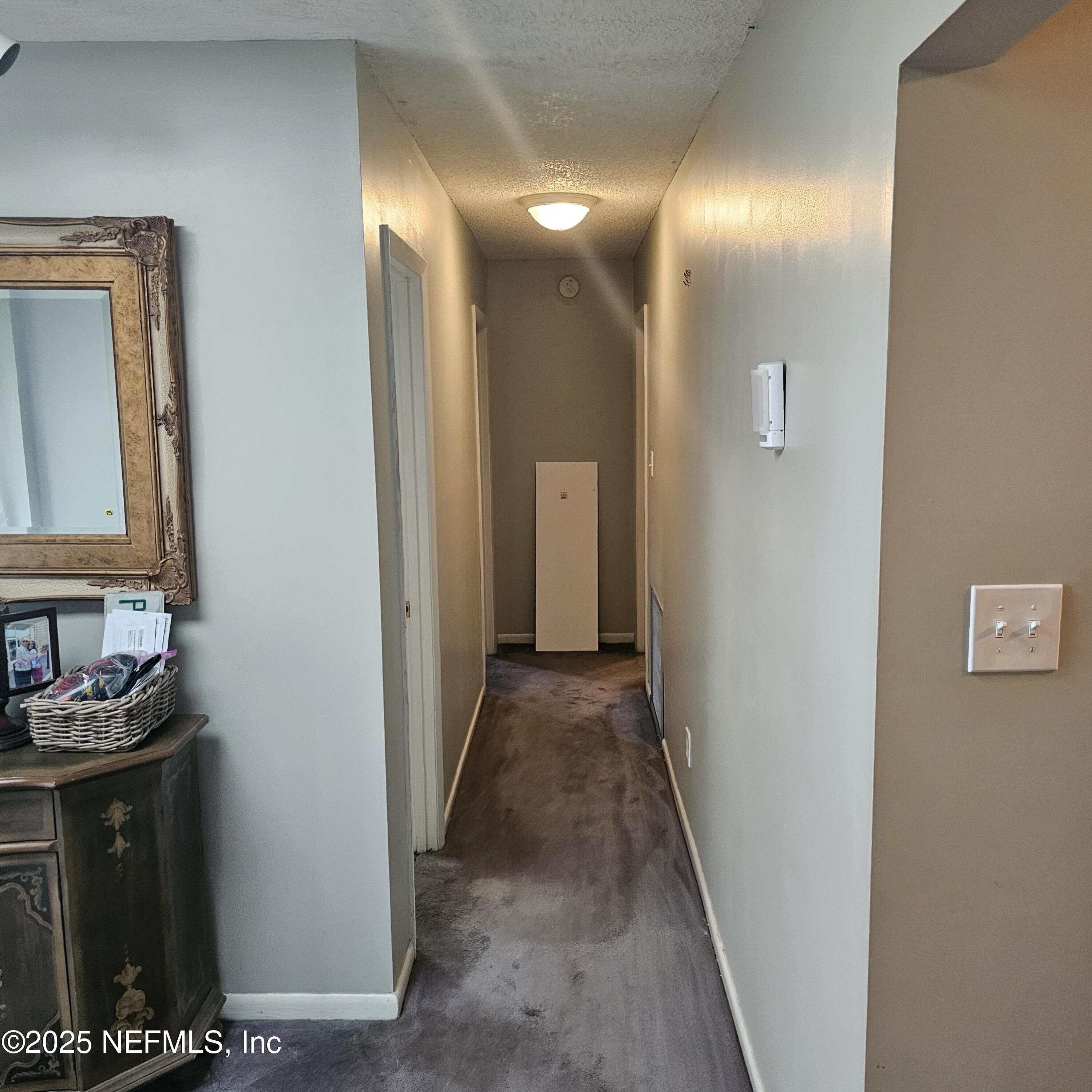 10596 Rutgers Road Jacksonville, FL 32218 - Photo 5 of 15 a view of a livingroom from a hallway