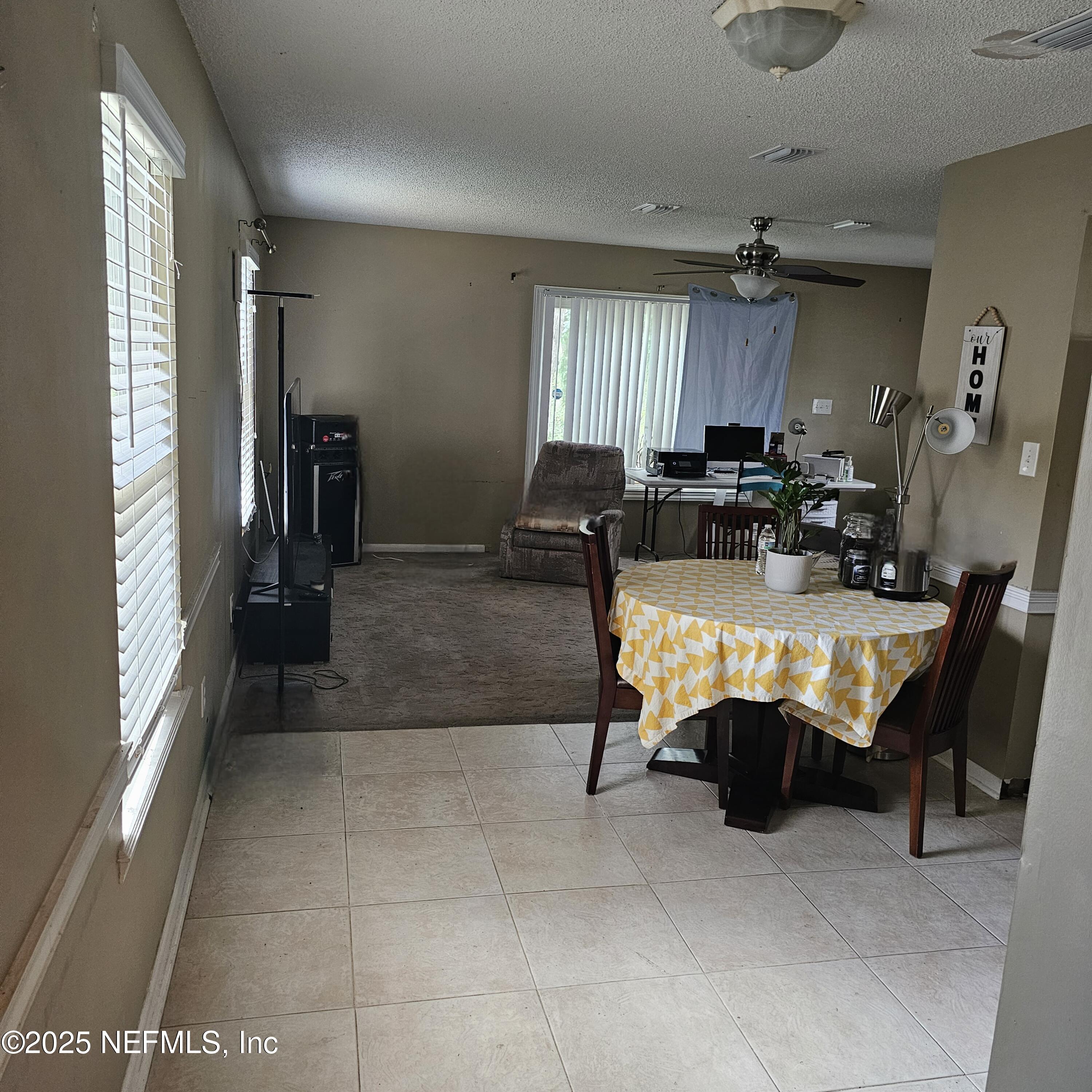 10596 Rutgers Road Jacksonville, FL 32218 - Photo 6 of 15 a living room with furniture a large window and gym equipment