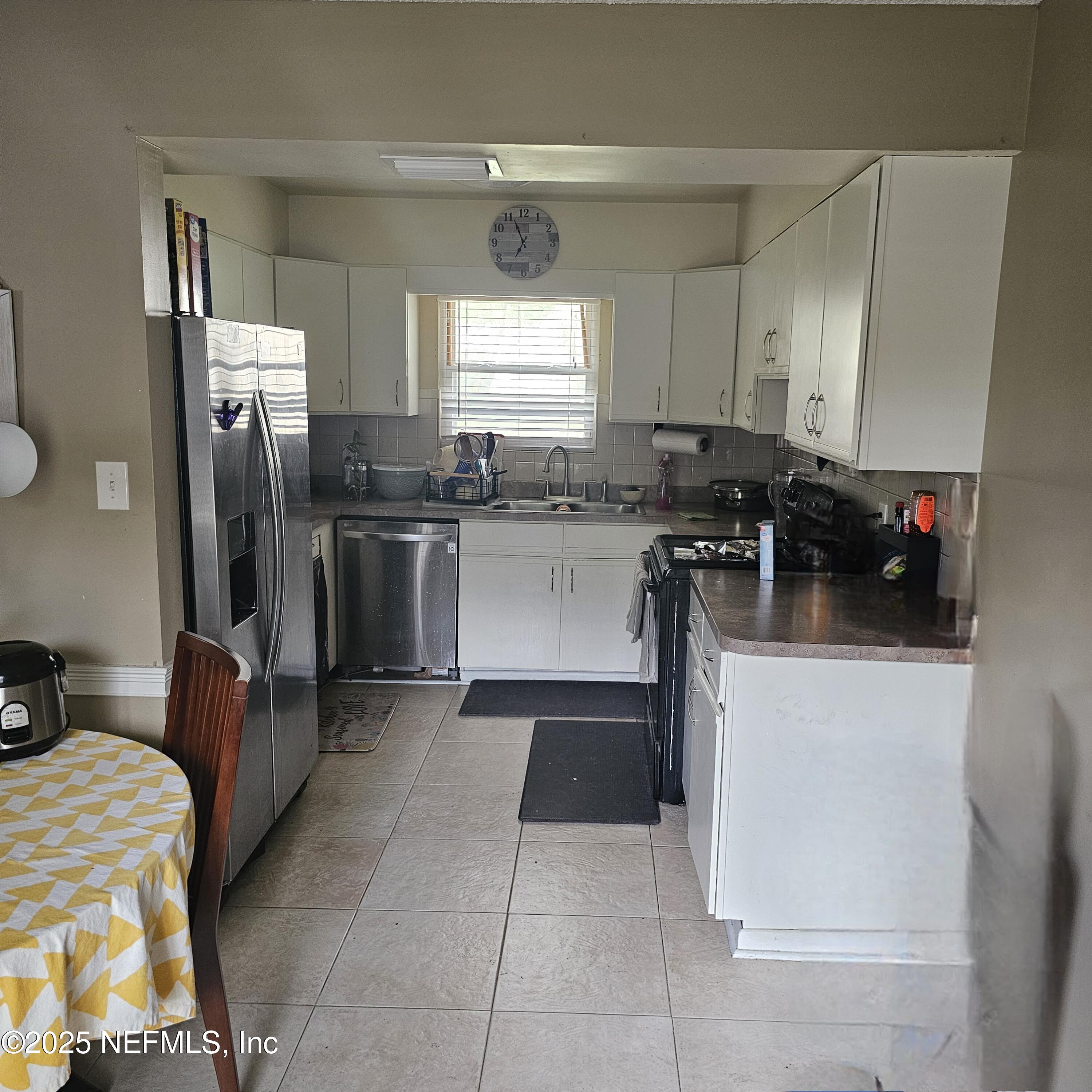 10596 Rutgers Road Jacksonville, FL 32218 - Photo 7 of 15 a kitchen with a refrigerator and a stove