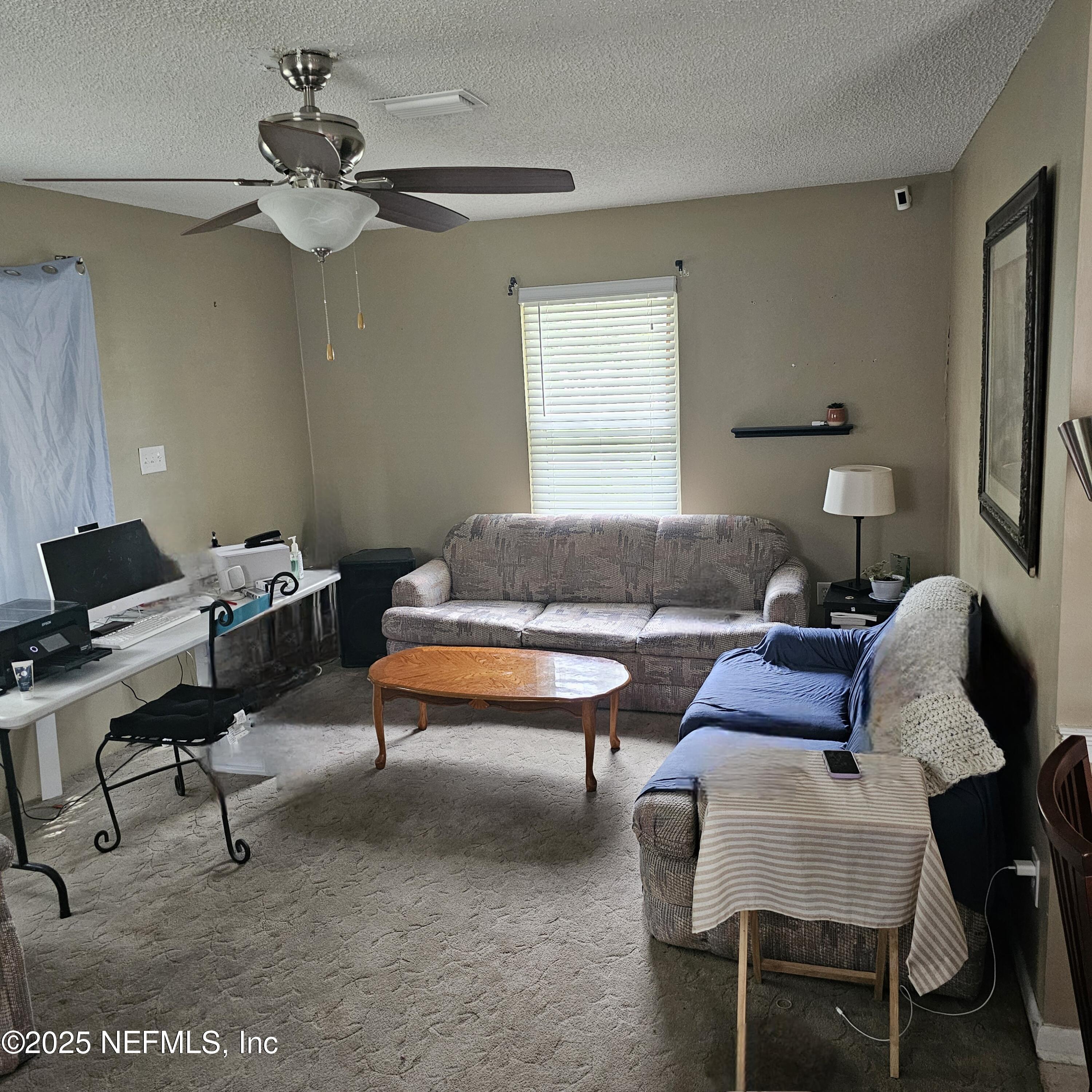 10596 Rutgers Road Jacksonville, FL 32218 - Photo 8 of 15 a living room with furniture and a window