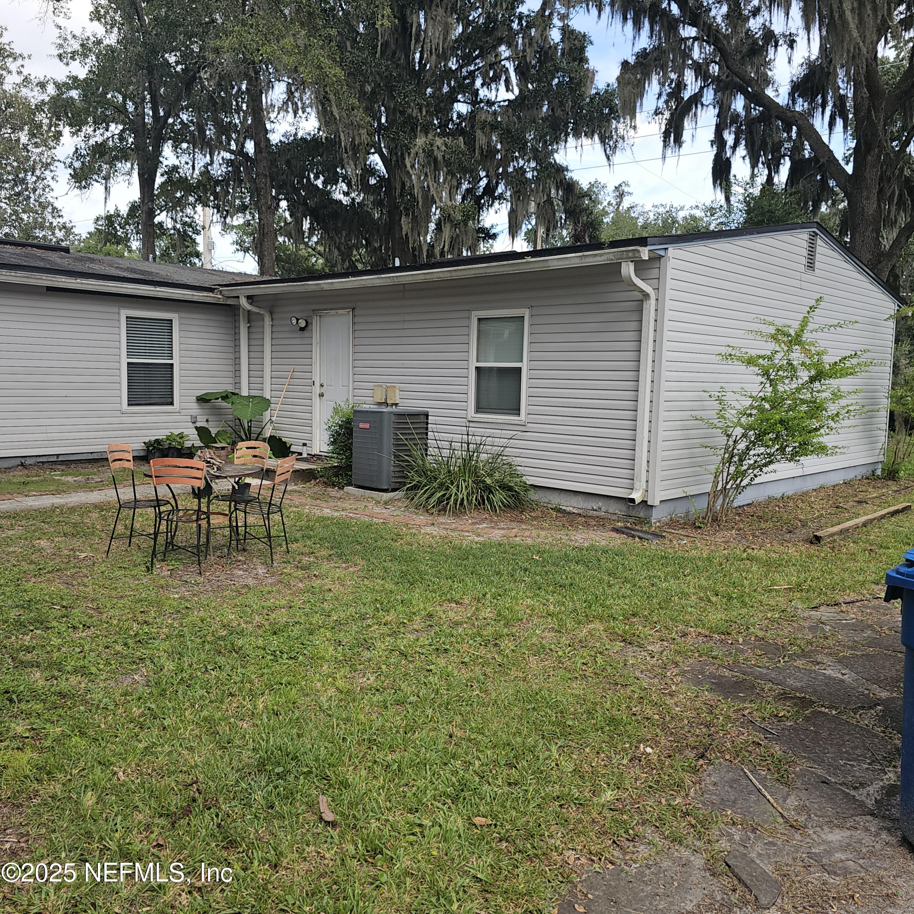 10596 Rutgers Road Jacksonville, FL 32218 - Photo 9 of 15 a backyard of a house with table and chairs