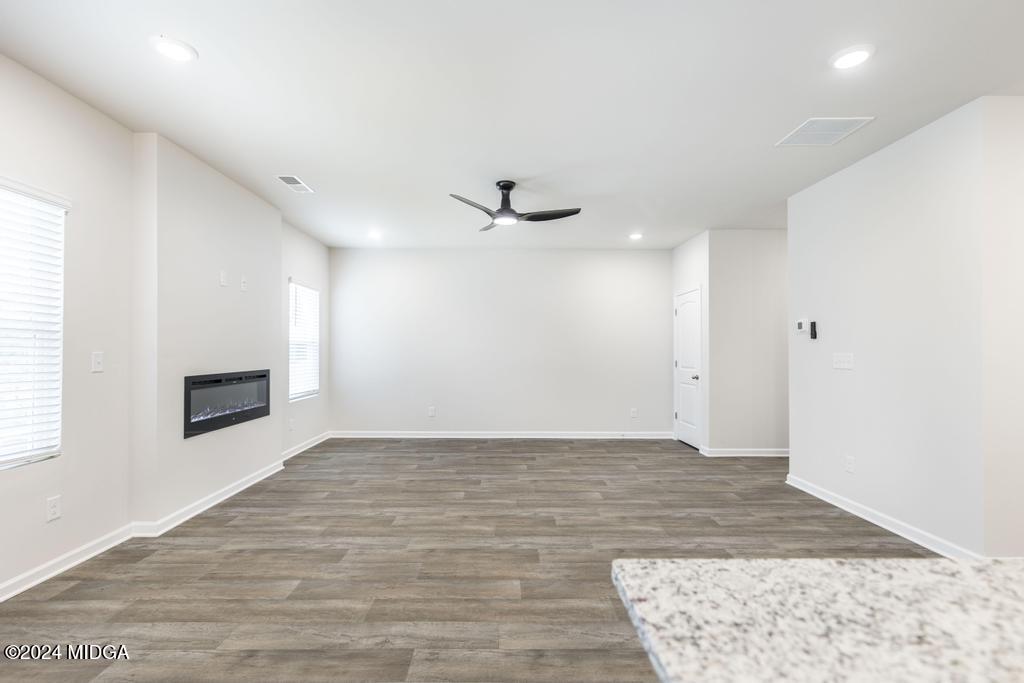 108 Cornfield Circle Perry, GA 31069 - Photo 11 of 39 a view of an empty room with wooden floor and a window