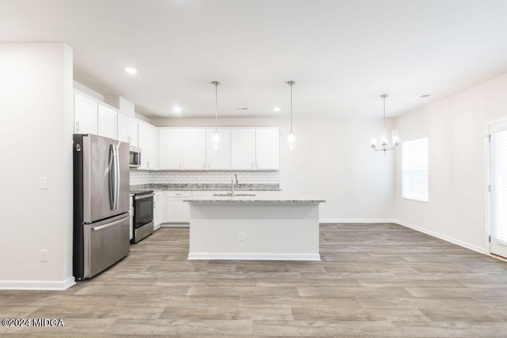 108 Cornfield Circle Perry, GA 31069 - Photo 12 of 39 a view of kitchen with granite countertop stainless steel appliances cabinets a sink and a counter top
