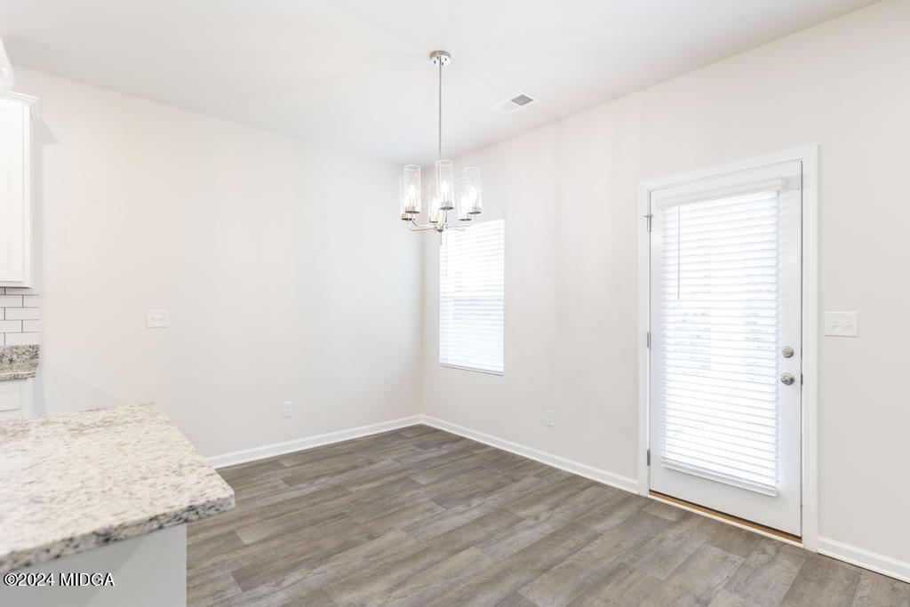 108 Cornfield Circle Perry, GA 31069 - Photo 13 of 39 an empty room with wooden floor and windows