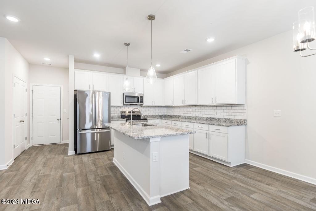 108 Cornfield Circle Perry, GA 31069 - Photo 14 of 39 a kitchen with refrigerator a sink and white cabinets