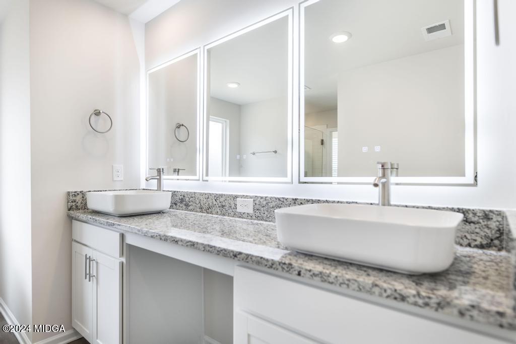 108 Cornfield Circle Perry, GA 31069 - Photo 25 of 39 a bathroom with a granite countertop sink and a mirror