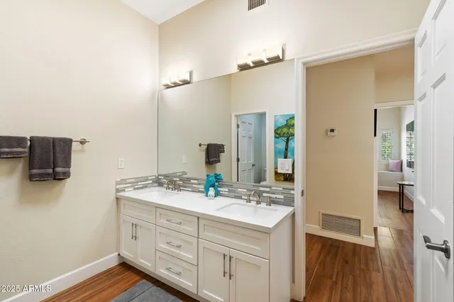 a view of a hallway with entryway wooden floor and windows