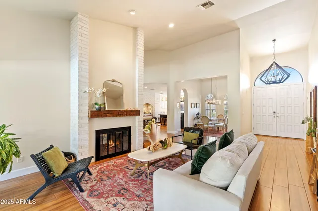 a living room with furniture a fireplace and a table