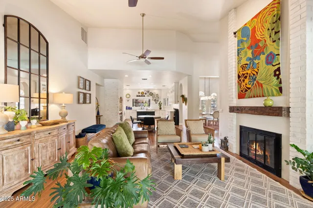 a living room with furniture a fireplace and a table