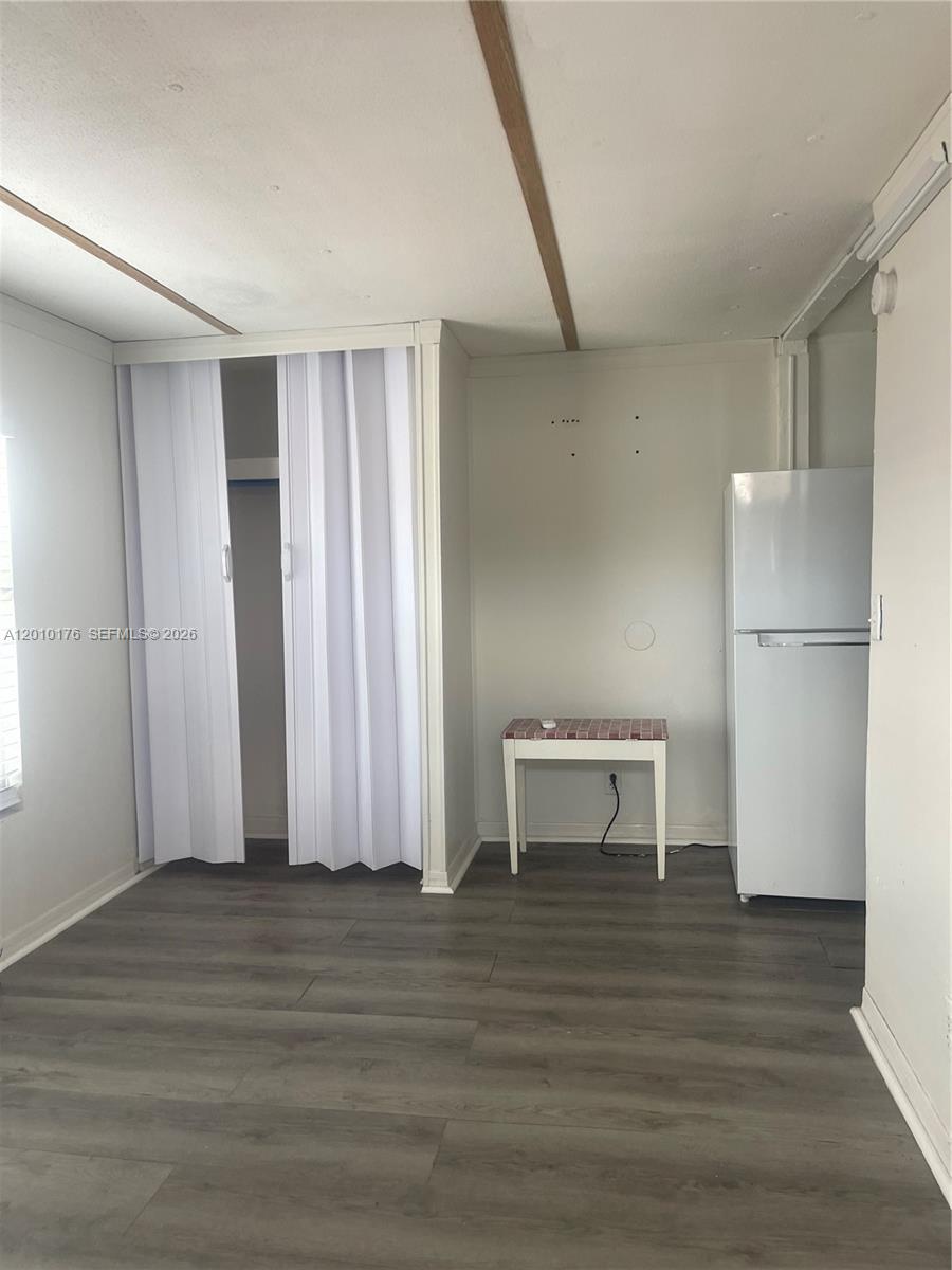 12401 West Okeechobee Road Hialeah, FL 33018 - Photo 3 of 4 a view of room with furniture and wooden floor
