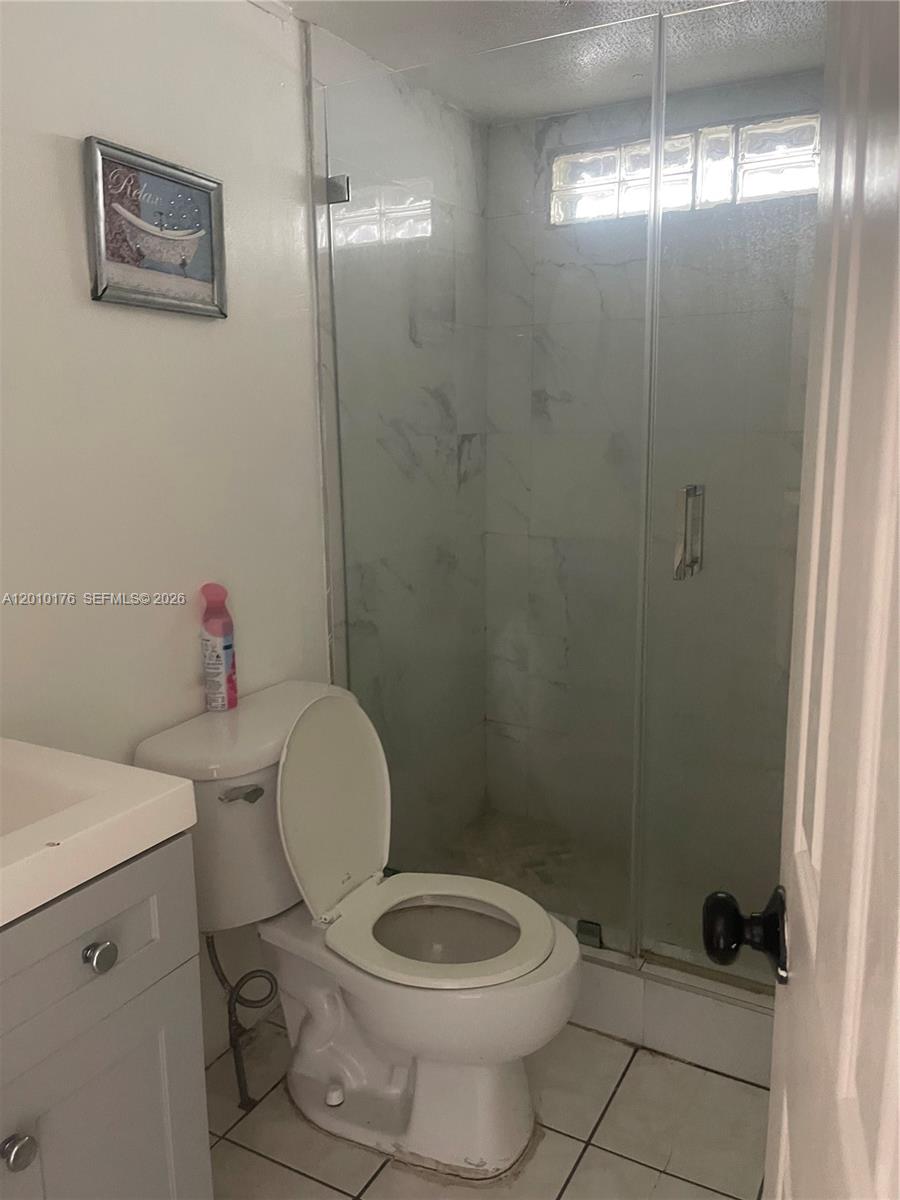 12401 West Okeechobee Road Hialeah, FL 33018 - Photo 4 of 4 a white toilet sitting next to a bathroom sink