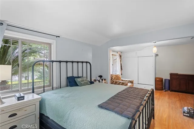 a bedroom with a bed and a large window