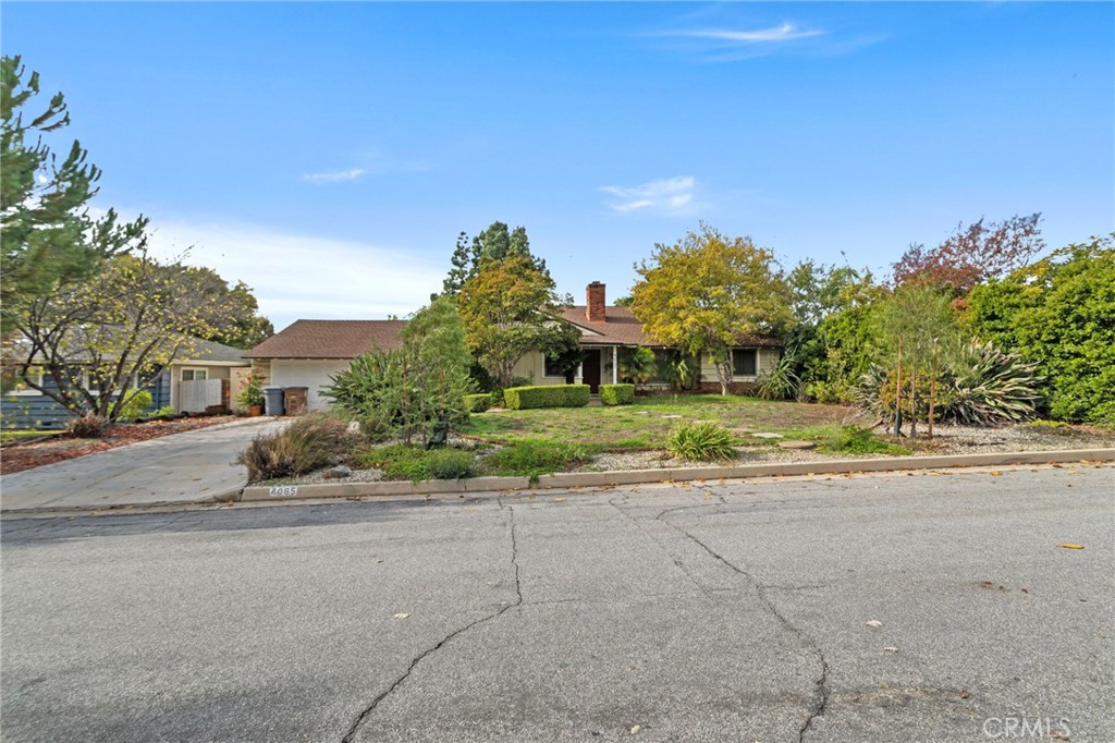 4065 Tenango Road Claremont, CA 91711 - Photo 28 of 30 a front view of a house with a yard and a garage