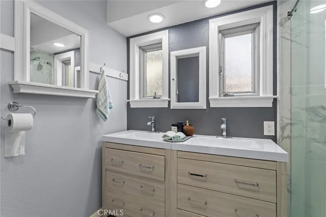 a bathroom with a sink vanity and mirror