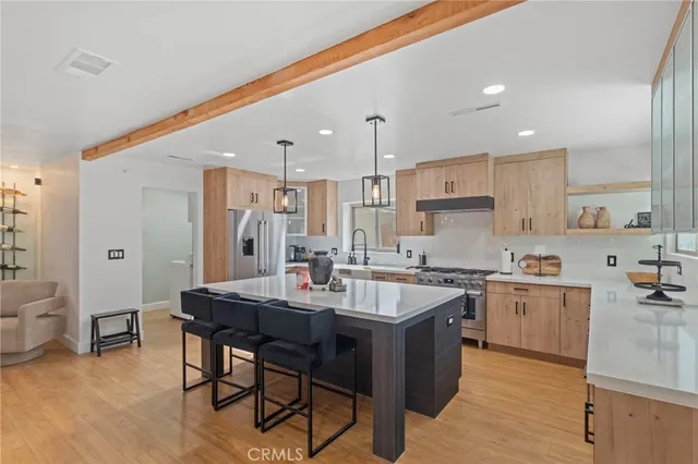 a kitchen with appliances a sink a counter top space and cabinets