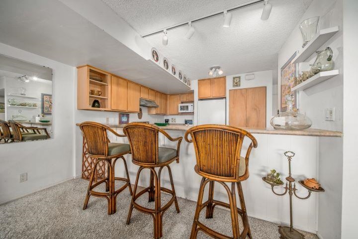 150 Puukolii Road, Unit 17 Lahaina, HI 96761 - Photo 13 of 40 a dining room with furniture and wooden floor