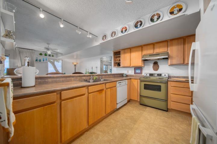 150 Puukolii Road, Unit 17 Lahaina, HI 96761 - Photo 15 of 40 a kitchen with granite countertop a sink stainless steel appliances and cabinets