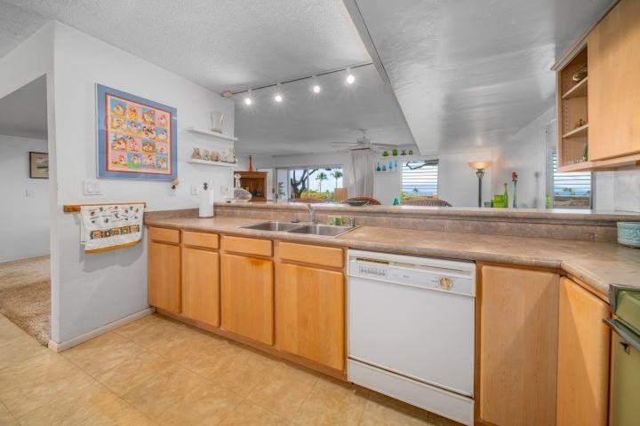 150 Puukolii Road, Unit 17 Lahaina, HI 96761 - Photo 17 of 40 a kitchen with stainless steel appliances granite countertop a sink stove and cabinets