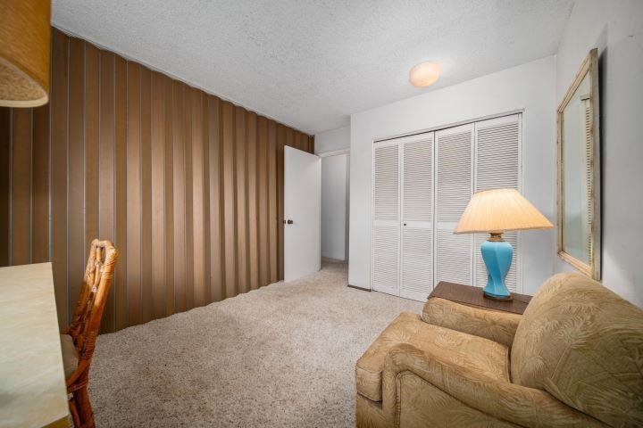 150 Puukolii Road, Unit 17 Lahaina, HI 96761 - Photo 24 of 40 a bed room with a bed and a chair