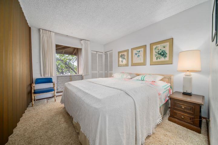 150 Puukolii Road, Unit 17 Lahaina, HI 96761 - Photo 25 of 40 a bedroom with a bed and a lamp on table