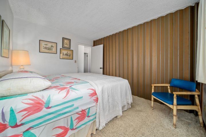 150 Puukolii Road, Unit 17 Lahaina, HI 96761 - Photo 27 of 40 a bedroom with a bed and a chair