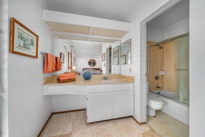 150 Puukolii Road, Unit 17 Lahaina, HI 96761 - Photo 38 of 40 a bathroom with a sink a toilet and shower curtain