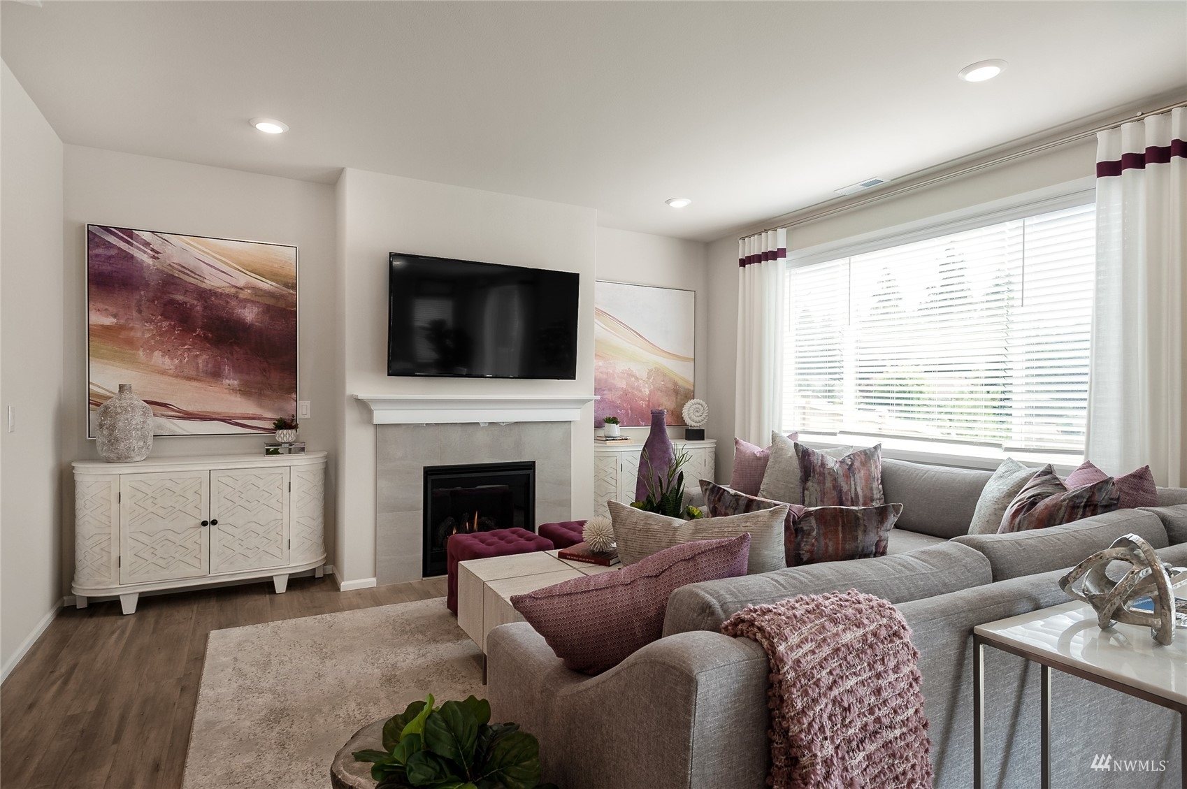 4018 233rd Street Southeast, Unit 76 Bothell, WA 98021 - Photo 13 of 18 a living room with furniture a flat screen tv and a fireplace