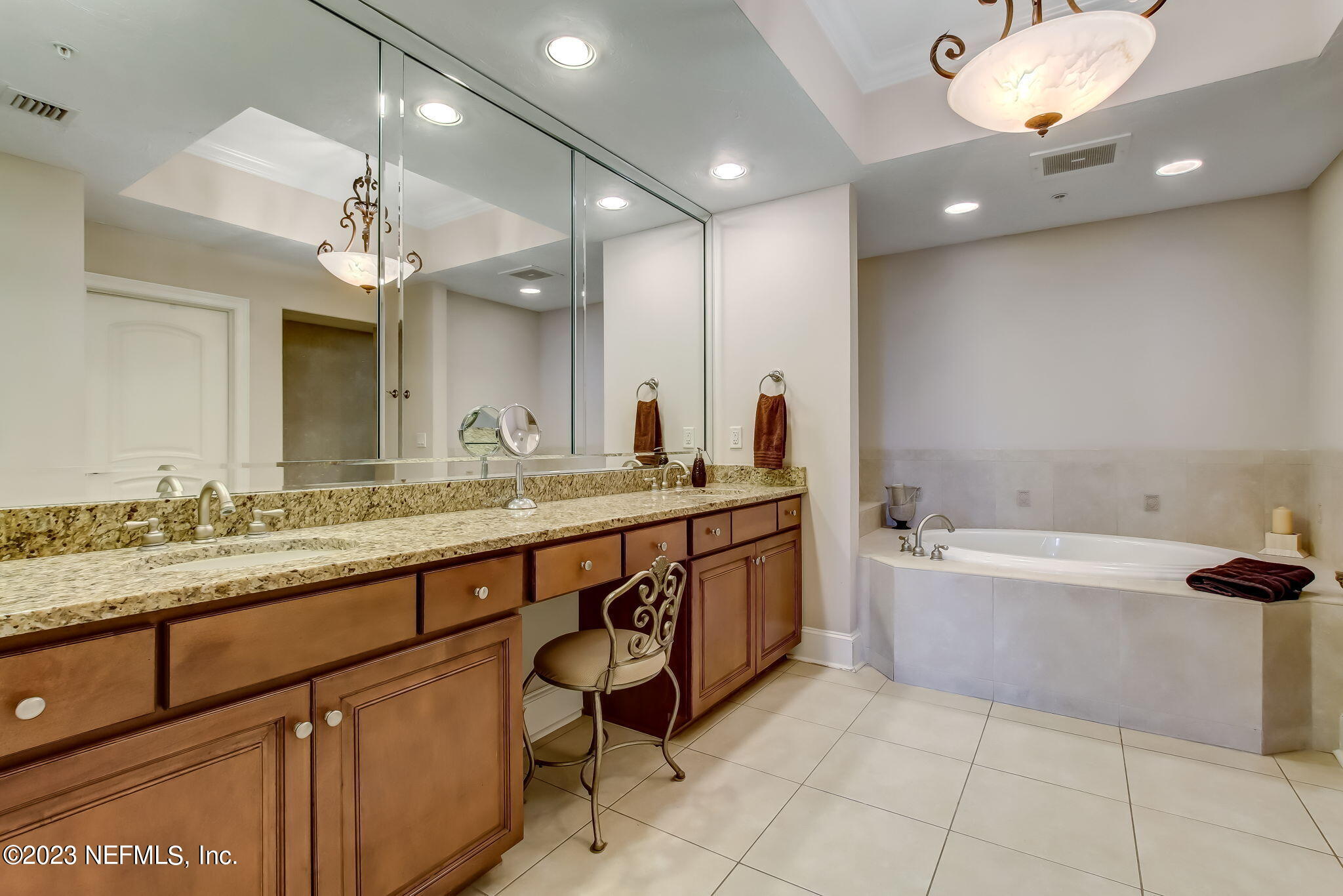 2358 Riverside Avenue, Unit 406 Jacksonville, FL 32204 - Photo 24 of 54 a bathroom with a granite countertop double vanity sink and a bathtub
