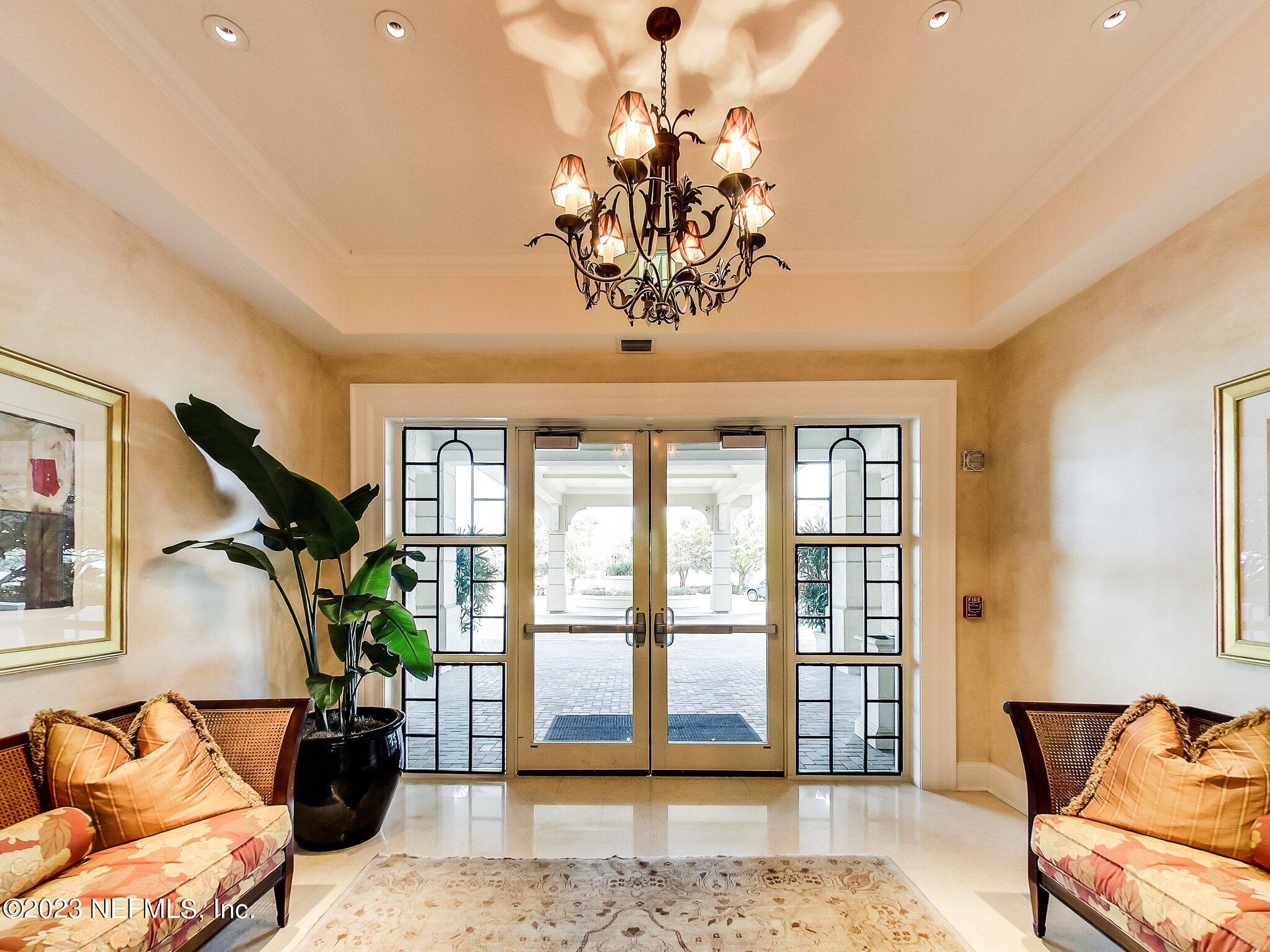 2358 Riverside Avenue, Unit 406 Jacksonville, FL 32204 - Photo 35 of 54 a living room with furniture windows and a chandelier