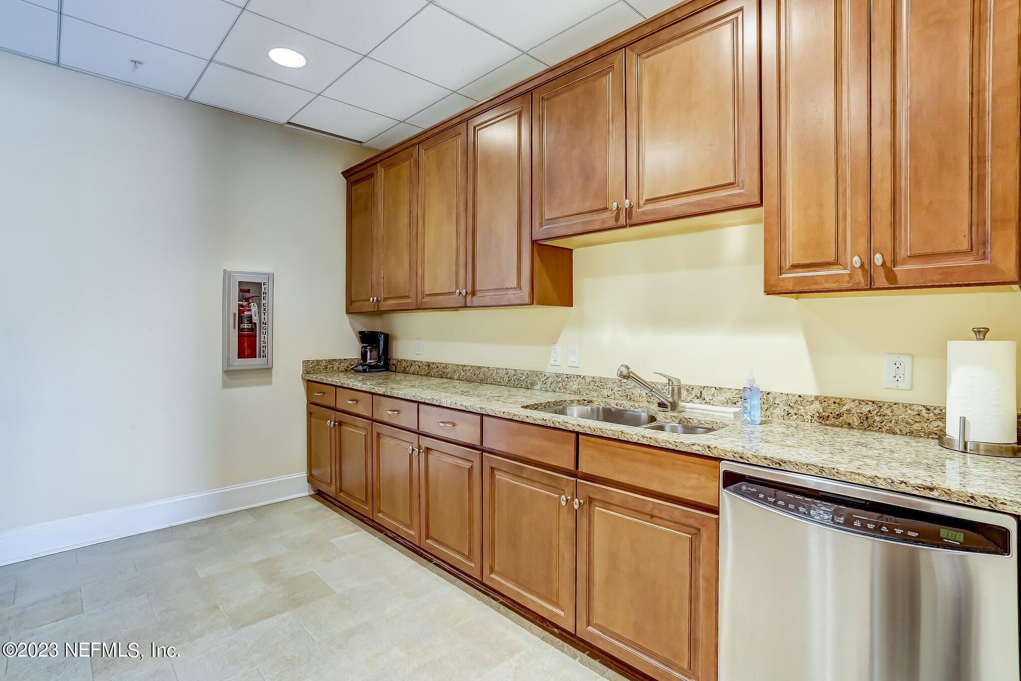 2358 Riverside Avenue, Unit 406 Jacksonville, FL 32204 - Photo 41 of 54 a kitchen with granite countertop stainless steel appliances a sink and cabinets