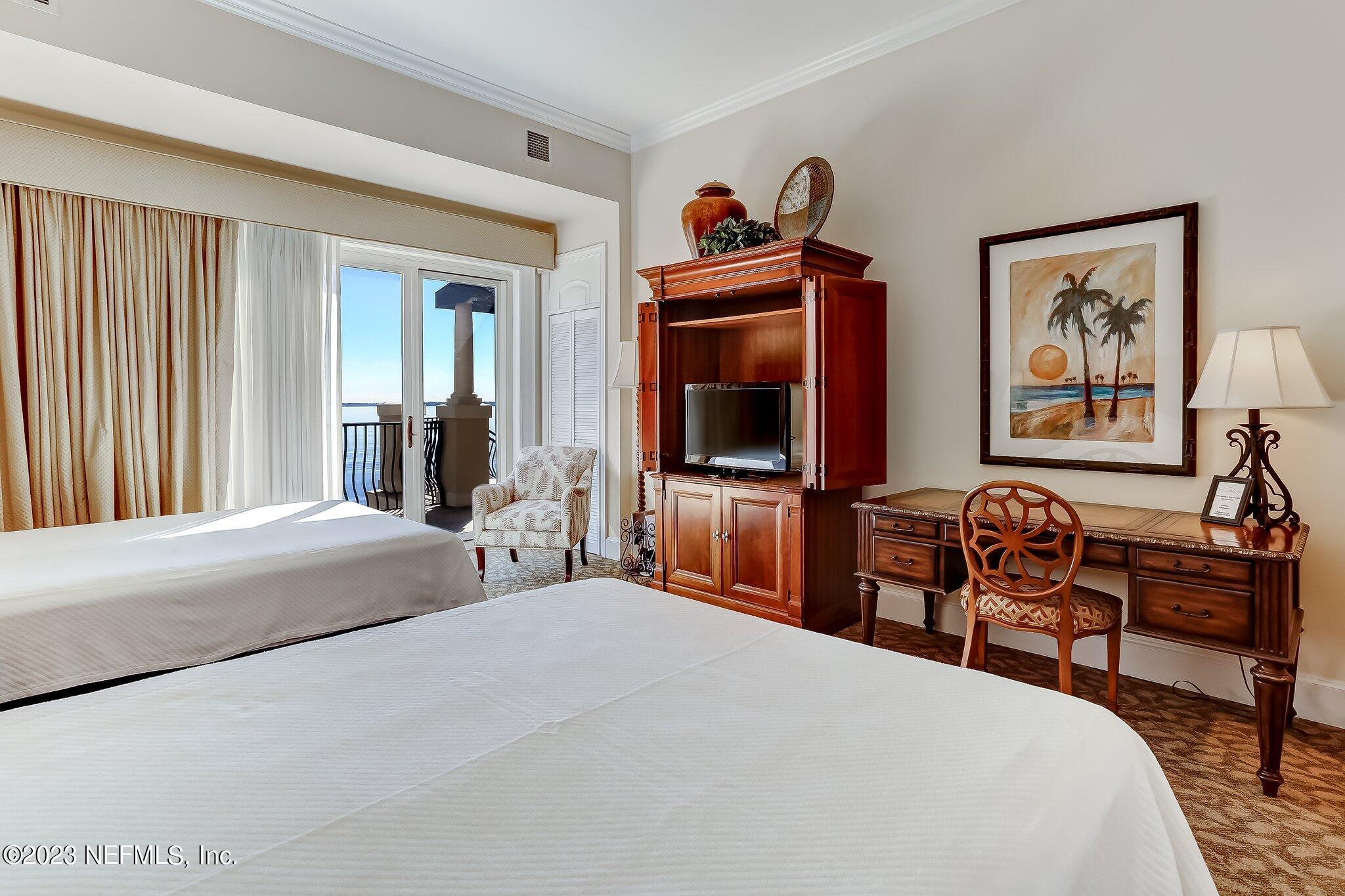 2358 Riverside Avenue, Unit 406 Jacksonville, FL 32204 - Photo 43 of 54 a bedroom with a bed and a flat screen tv