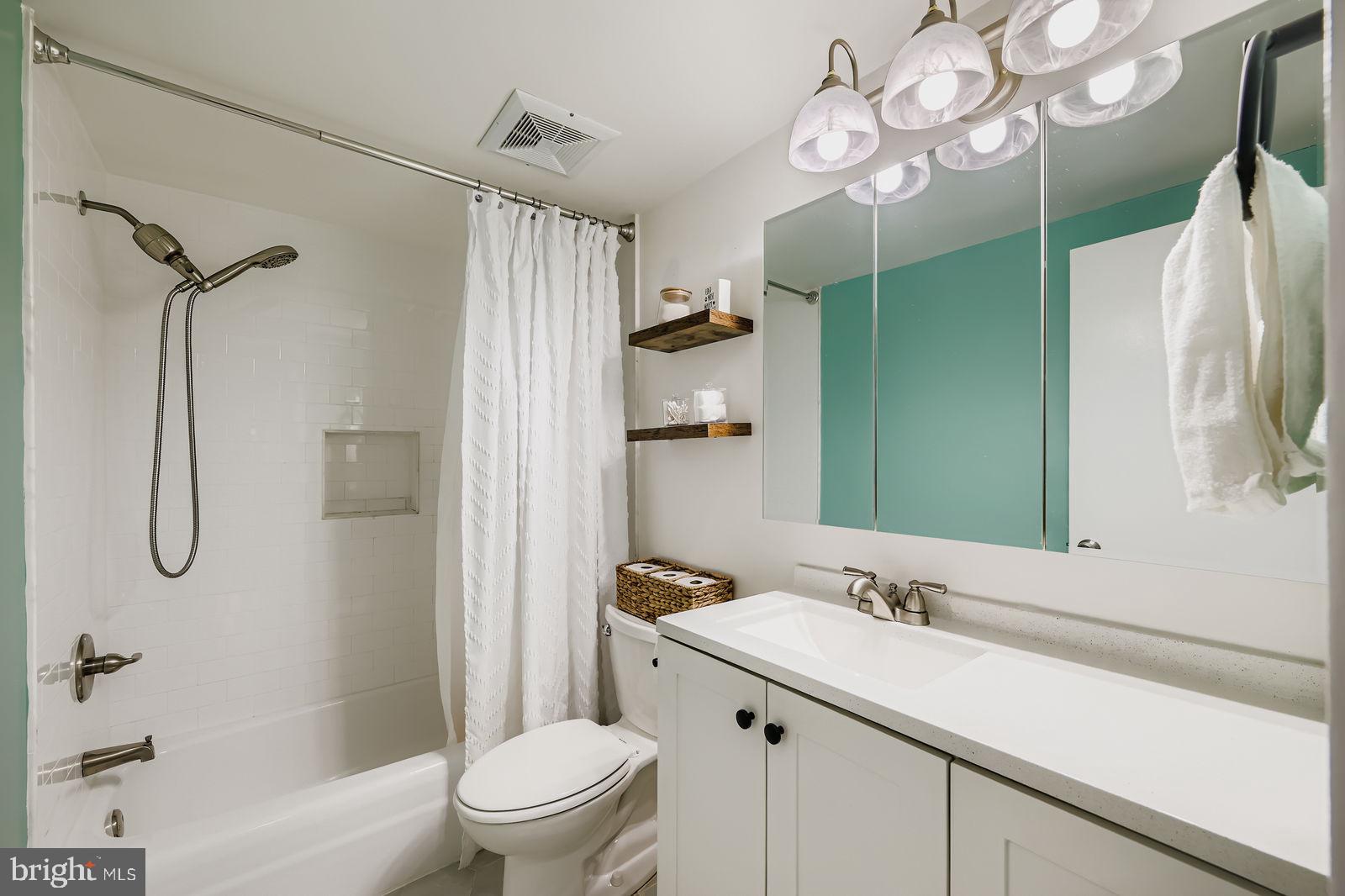 9900 Georgia Avenue, Unit 27716 Silver Spring, MD 20902 - Photo 20 of 37 a bathroom with a sink a toilet and shower