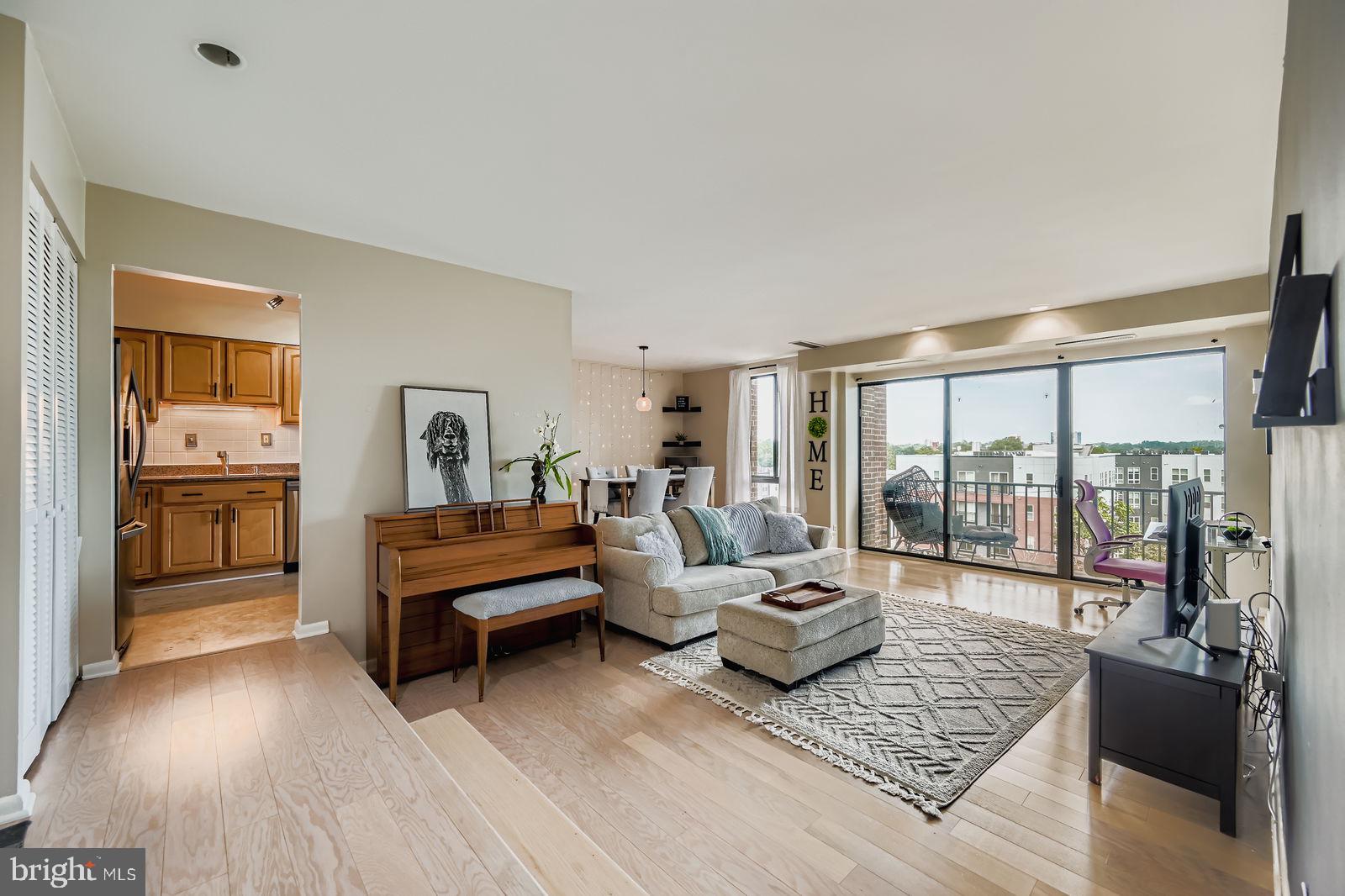 9900 Georgia Avenue, Unit 27716 Silver Spring, MD 20902 - Photo 4 of 37 a living room with furniture and a wooden floor
