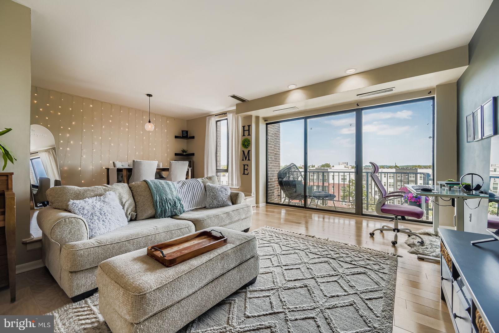 9900 Georgia Avenue, Unit 27716 Silver Spring, MD 20902 - Photo 6 of 37 a living room with furniture and a large window