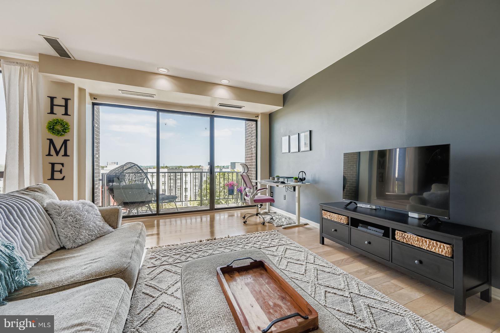 9900 Georgia Avenue, Unit 27716 Silver Spring, MD 20902 - Photo 7 of 37 a living room with furniture and a flat screen tv