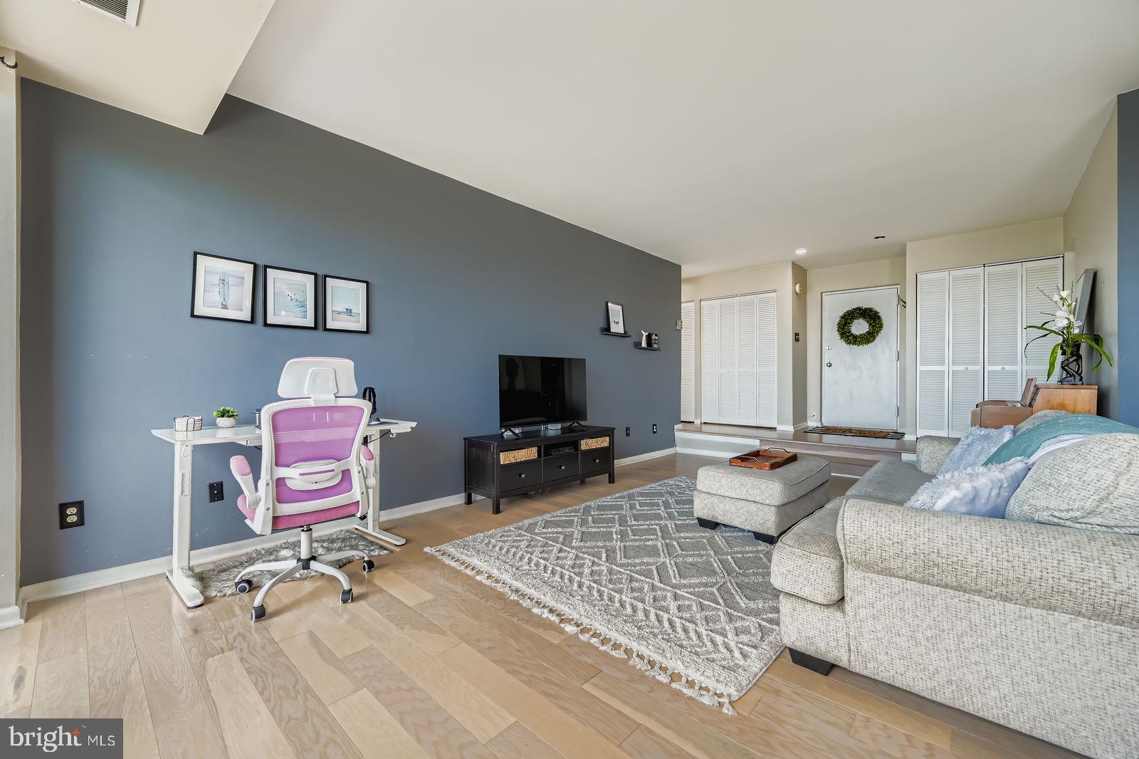 9900 Georgia Avenue, Unit 27716 Silver Spring, MD 20902 - Photo 8 of 37 a living room with furniture and a flat screen tv